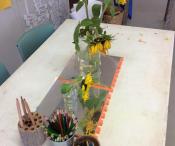 Artrs and craft table with sun flowers and colouring pencils on it